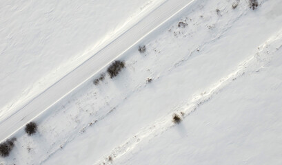 Obraz premium Top view of rural snowy road in winter