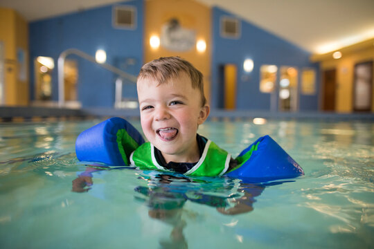 Portrait of happy little boy in a swimming pool