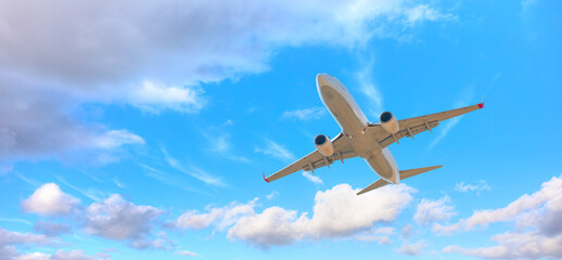 White passenger airplane over the clouds  - Travel by air transport