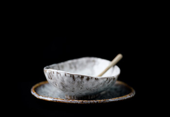 Traditional, handcrafted ceramic on dark background. Soft focus. Copy space.