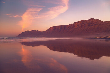 Fototapeta premium Cliffs of Caleta de Famara Beach at sunset, Lanzarote, Canary Islands, Spain.