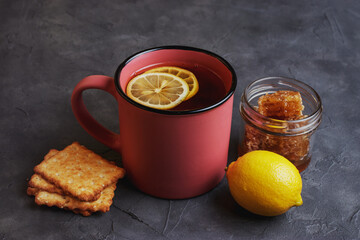 Tea with lemon, honey and grain biscuits. Traditional folk remedy for colds. 