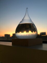 City sunset reflected in glass beads, water balls, storm glass.