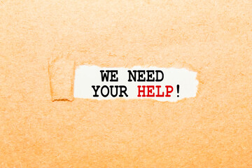 text WE NEED YOUR HELP on a torn piece of paper, business concept