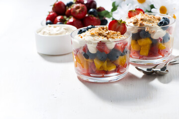 Assorted fresh fruit with custard and white background, horizontal