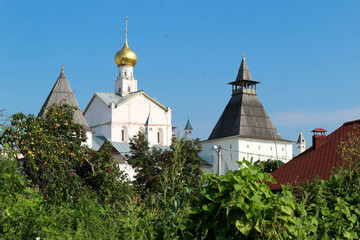 Summer view to famous russian landmark Rostov the great kremlin surrounded by green trees