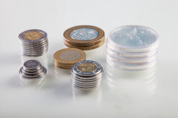 Mexican peso coins on white background