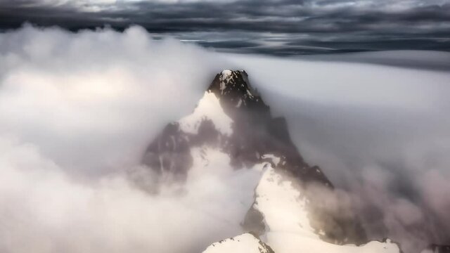 Aerial landscape view of the snow covered mountain range near Squamish and Vancouver, British Columbia, Canada. Artistic Dramatic Colorful Sunset Render. Parallax Animation