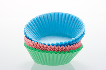 Stack of colorful cupcake cases.