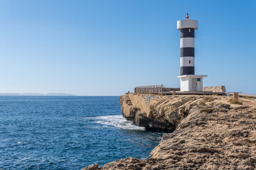 Fototapeta na wymiar Colonia de Sant Jordi lighthouse on a sunny and winding day