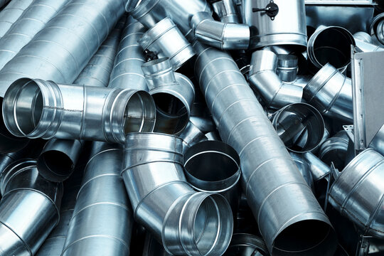 Pile of pipes and parts for duct systems. Industrial ventilation