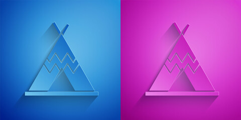 Paper cut Traditional indian teepee or wigwam icon isolated on blue and purple background. Indian tent. Paper art style. Vector. © Oksana