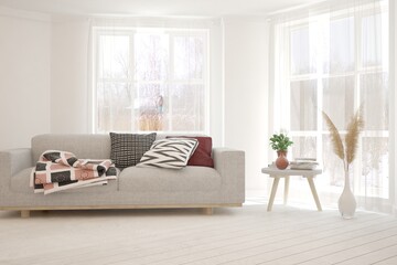 White living room with sofa and winter landscape in window. Scandinavian interior design. 3D illustration
