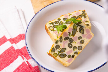 Vegetable pudding with green beans and ham.