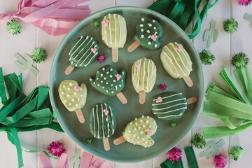 Cactus cake pops on a green plate