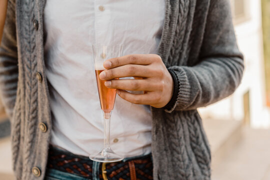 Close up of male hand holding a glass of champagne