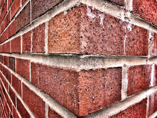 old brick wall corner showing its aged look after years of exposure to the elements.  Binghamton NY in Broome County in Upstate NY.