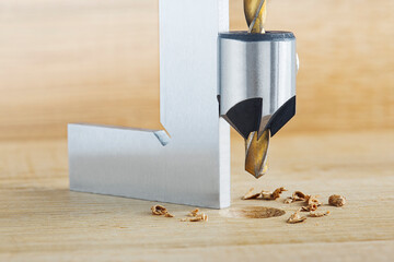 Countersink drill bit with steel triangle ruler make sink in hole for screw in wooden oak plank