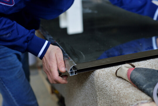 Production Of Cabinet Furniture Small-Sized Companies And People Concept. Young Man Working At The Furniture Production. Assembly Of A Mirror Door For A Sliding Wardrobe