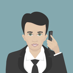 Young businessman communicates by smartphone.