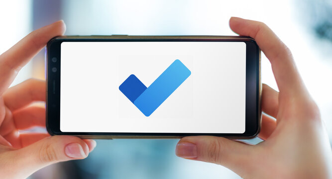 Hands holding smartphone displaying logo of Microsoft To Do