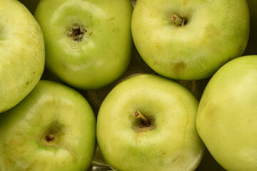 Several juicy green apples, close-up, top view.