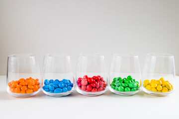 M&M's candy in the glasses, colorful candy, multicolored gradient