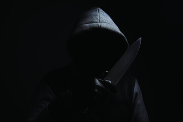 a man holding a large knife threatens