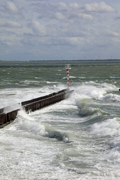 Waves Crashing On The Wall And Lighthouse