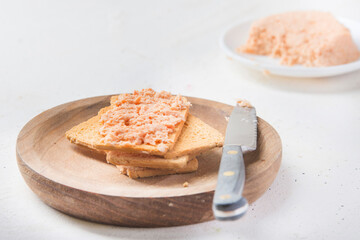 salmon pate with red caviar served, sliced bread and parrot.