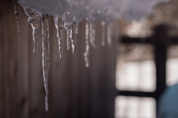 Detail of icicles forming on the lower part of the roof outside.