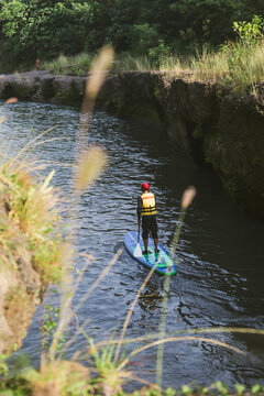 Young man on the SUP board at river