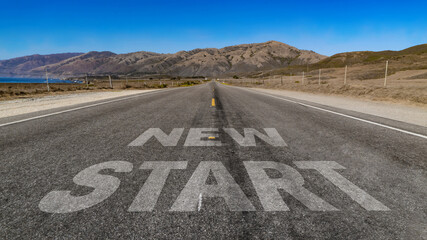 New Start written on highway road to the mountain