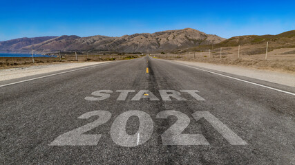Start 2021 written on highway road to the mountain