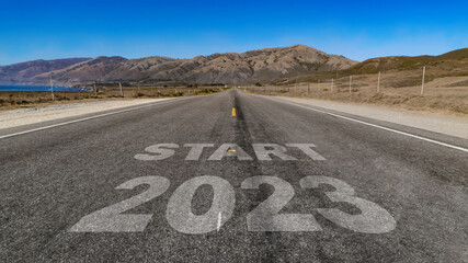 Start 2023 written on highway road to the mountain