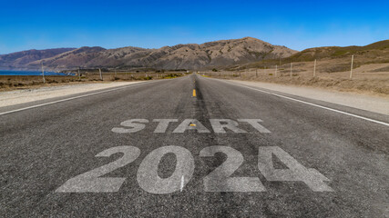 Start 2024 written on highway road to the mountain