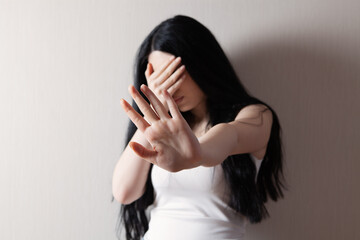 Fototapeta premium Closeup image of a woman outstretched hand and showing stop hand sign