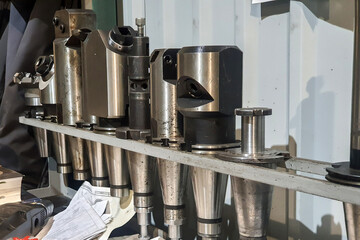 Rack with mandrels for milling cutters for a cnc machine.
