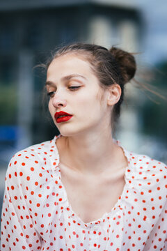 Close-up portrait of young woman wearing red lipstick