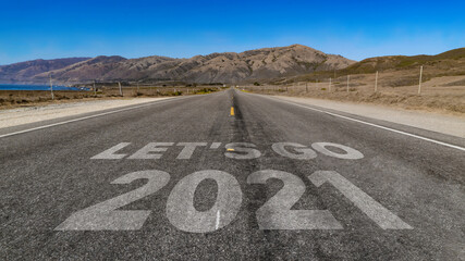 Let's Go 2021 written on highway road to the mountain