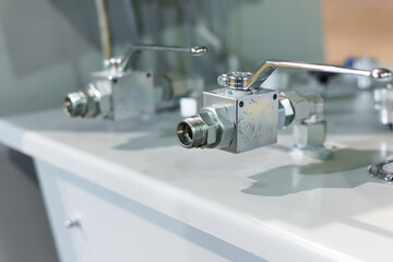 Hydraulic feed control system with tap and pressure gauge.