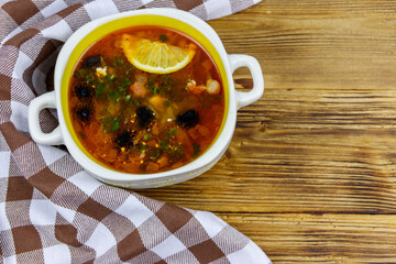 Traditional russian hodgepodge soup on a wooden table. Top view