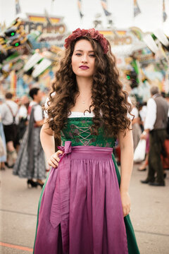 Young woman with long curly hair in Oktoberfest dress