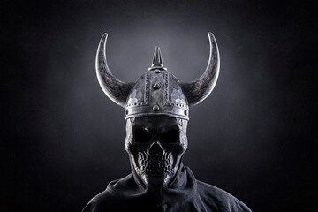 Skeleton warrior with horned helmet in the dark