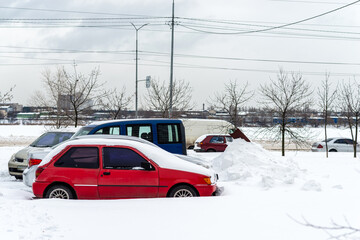 Frozen and snow covered automobiles cars in the city yard