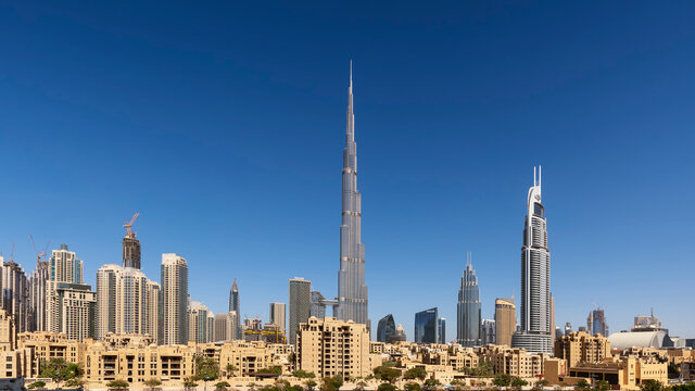 Dubai skyline with Burj Khalifa against clear blue sky