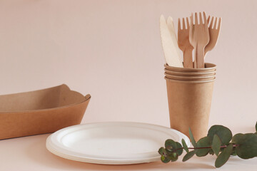 Eco-friendly disposable craft kitchenware. Knives, forks, paper cups and empty dishes. Zero waste and recycling concept. Ecology problem