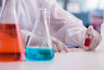 Chemist working in the laboratory with hazardous chemicals