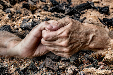 old hands on a ash background