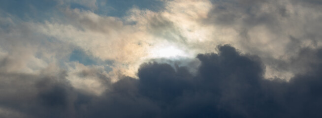 Fototapeta premium Dark cloud in a stormy sky with a small light cloud